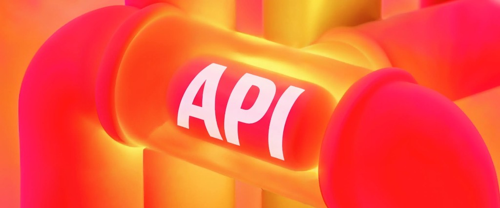 3D-иллюстрация открытого API Яндекс KIT: светящиеся трубы-каналы данных с надписью API в центре, в градиенте розового, оранжевого и жёлтого — метафора обмена данными и интеграций.